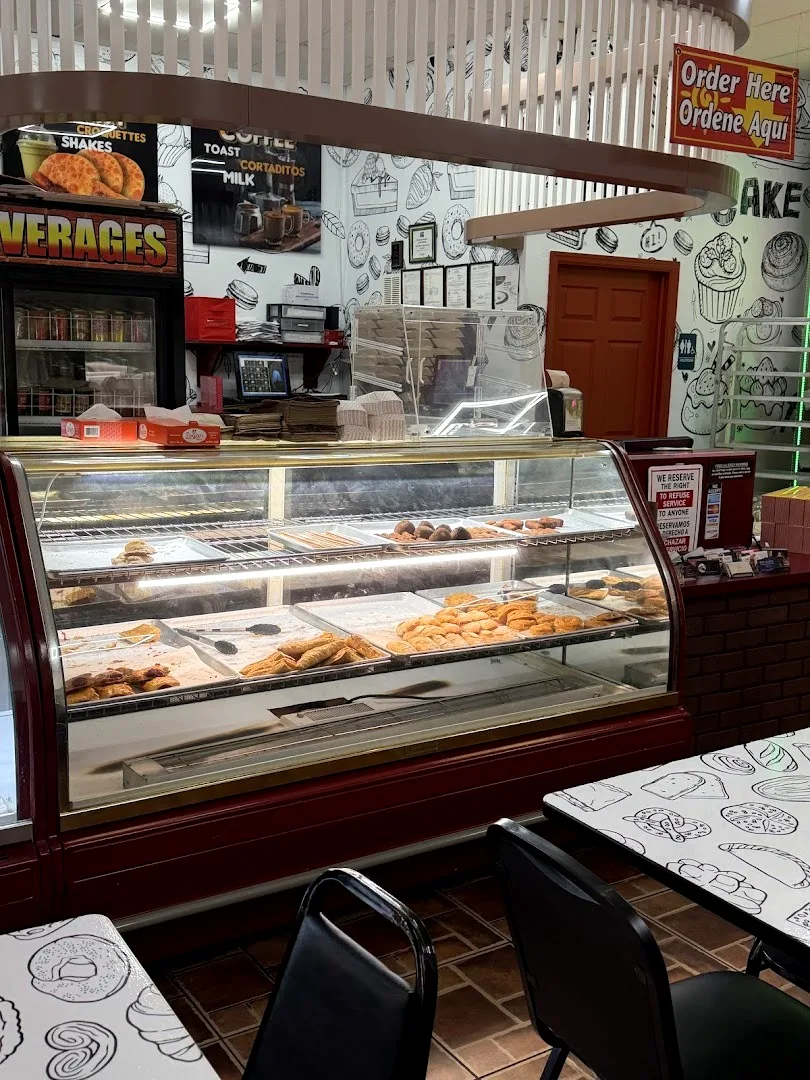 The counter and glass case, with the wall of pastry drawings