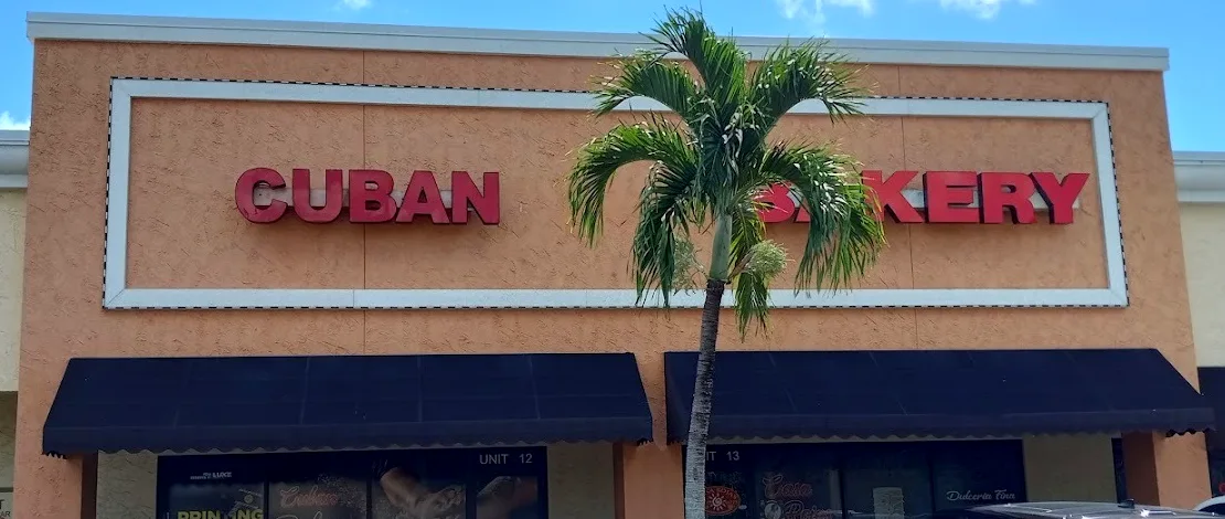 The Casa Rojas storefront with the red CUBAN BAKERY sign and a palm tree
